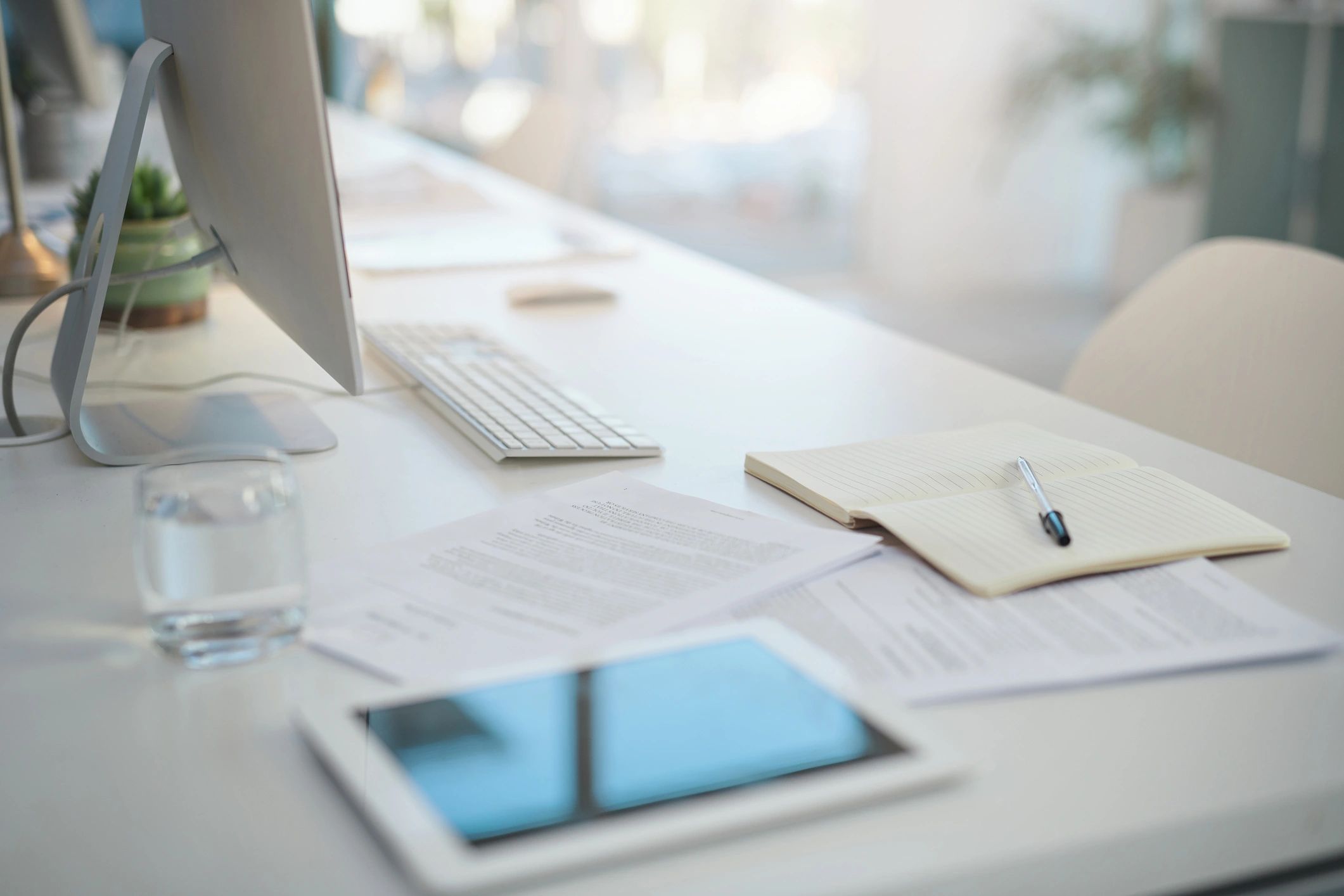 Compliance documents and stationery on a modern office desk